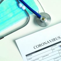 Coronavirus blood test concept. Laboratory table with medical form Coronavirus test, respiratory mask, stethoscope, pills. 2019-nCoV Coronavirus originating in Wuhan, China